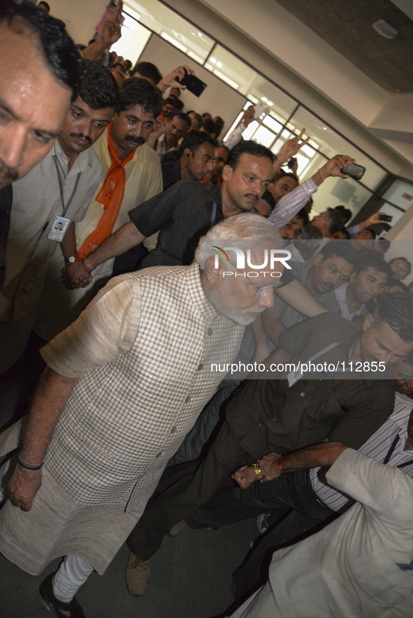 Narendra Modi flashed a triumphant V as he reached his party's office in Gandhinagar