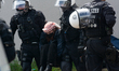 The police are arresting the students who are refusing to leave the entrance access to the...