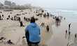 Palestinians enjoy a day at the beach of the Mediterranean sea on the coast of Gaza city,...