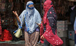 Girls are covering their faces to protect themselves from the scorching heat on a hot summ...