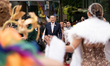 Prime Minister Srettha Thavisin is being greeted by drag queens on a rainbow road while ov...