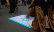 Protesters are walking over the Israel flags as they are attending a solidarity rally with...