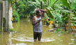 People are going to houses through flood water in Kelaniya, Sri Lanka, on June 2, 2024. 