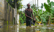People are going to houses through flood water in Kelaniya, Sri Lanka, on June 2, 2024. 