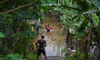 People are going to houses through flood water in Kelaniya, Sri Lanka, on June 2, 2024. 