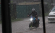 A man is riding his bike through flood water in Kelaniya, Sri Lanka, on June 2, 2024. 