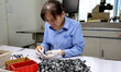 A worker is producing semiconductor products at a semiconductor manufacturing enterprise i...