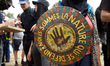 The shield is reading 'We are the nature which defends itself', the motto of the 'soulevem...