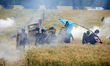 Black bloc is standing in a field of wheat during skirmishes with riot police. Nearly 5,00...