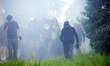 A black bloc is moving amid clouds of tear gas. Nearly 5,000 people are participating in a...