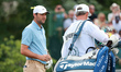 Scottie Scheffler of the United States interacts with his caddy on the 8th green during Da...