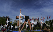 Yoga enthusiasts are performing during a mass yoga exercise in Bangkok, Thailand, on June...