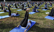Yoga enthusiasts are performing during a mass yoga exercise in Bangkok, Thailand, on June...