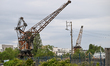 CAEN, FRANCE - JUNE 16: Old gantry crane standing at the Caen canal wharf in the harbor,...