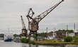 CAEN, FRANCE - JUNE 16: Old gantry crane standing at the Caen canal wharf in the harbor,...