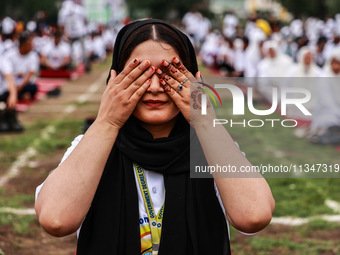 A girl is taking part in the 10th International Yoga Day Celebrations in Baramulla, Jammu and Kashmir, India, on June 21, 2024. Indian Prime... by Nasir Kachroo/NurPhoto