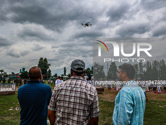 People are watching as a drone is flying during the 10th International Yoga Day Celebrations in Baramulla, Jammu and Kashmir, India, on June... by Nasir Kachroo/NurPhoto