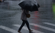 A woman is walking with an umbrella in stormy weather in Shanghai, China, on June 30, 2024...