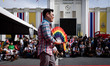 Thailand Deputy Foreign Minister Jakkapong Sangmanee is showing a rainbow fan while going...