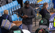 Carl Lewis is smiling after watching his protege Louie Hinchliffe win the Men's 100m durin...
