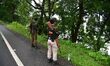 Indian forest guards are patrolling a flooded area as floods hit Kaziranga National Park i...