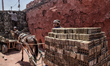 The brick factory workers using carriages pulled by donkey to move the brick ovens in the...
