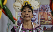A woman with a wreath of corn leaves is posing at the Pre-Hispanic Food Fair 2024 at the M...