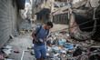 A Palestinian young man is checking the damage in a house hit by Israeli bombardment in Nu...