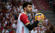 Polish national volleyball team player Marcin Janusz is playing in a game between Poland a...
