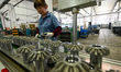 A worker is producing gears at a workshop at a gear factory in Taizhou, Jiangsu province,...