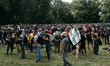 Demonstrators are picnicking before the start of a march as part of a rally against the co...