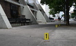 Evidence markers are being placed at the crime scene where shell casings are being discove...