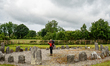 A hiker is taking a look at the Drumskinny Stone Circle, dating from between 1600 and 1200...