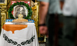 A photograph of Makarios is being seen on a table with the flag of Cyprus during the servi...