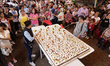 People are viewing a giant 100kg cake at the shrine of the Lord of Calvary in the town of...