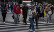 People are walking in the business district during rush hours in Jakarta, Indonesia, on Au...