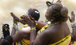 Osun devotees are praying at the Osun River during the Osun Osogbo Festival in Osogbo, Osu...