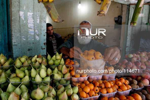 A Palestinian man sells fruit in a shop in Rafah in the southern Gaza Strip on May 17, 2014. 