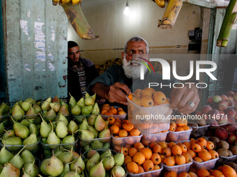 A Palestinian man sells fruit in a shop in Rafah in the southern Gaza Strip on May 17, 2014. (