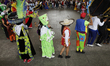 People are dancing comparsas and chinelos during the Enchilada Fair in the esplanade of th...