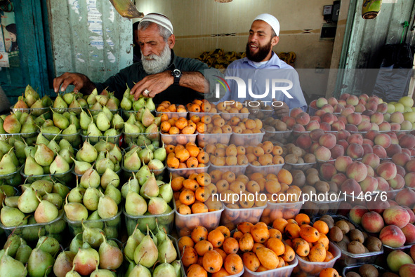 A Palestinian man sells fruit in a shop in Rafah in the southern Gaza Strip on May 17, 2014. 