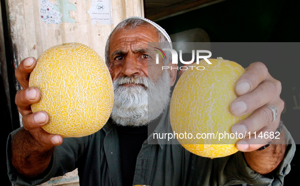 A Palestinian man displays melon in the shop in Rafah in the southern Gaza Strip on May 17, 2014. 