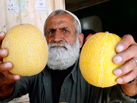 A Palestinian man displays melon in the shop in Rafah in the southern Gaza Strip on May 17, 2014. (