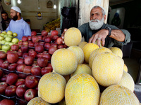 A Palestinian man sells fruit in a shop in Rafah in the southern Gaza Strip on May 17, 2014. (