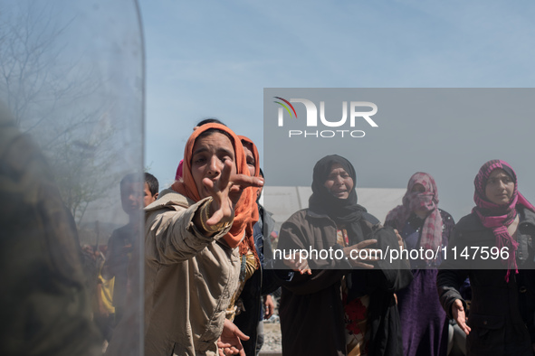 Womens crying after crossing the police line in the rail tracks in Idomeni on April 7, 2016. 