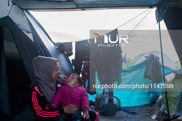 Mum and her baby waking up, in Idomeni camp on April 5, 2016. 
