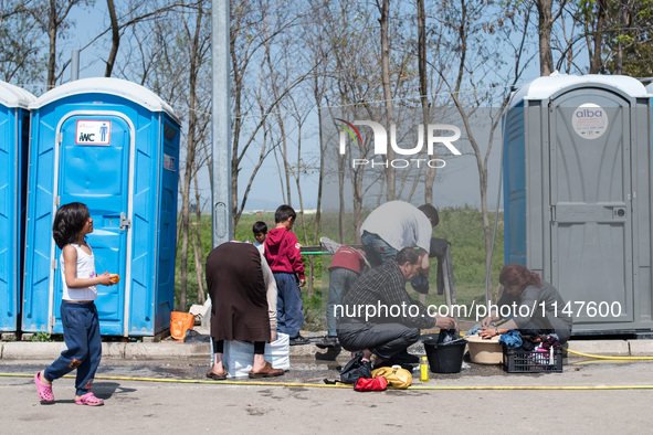 Refugees cleaning their clothes in Eko Station, Polykastro on April 4, 2016 