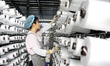 A worker is working on the production line of a workshop of a woven bag company in Lianyun...