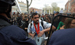 People dance in front of riot police at the end of a protest against the El-Khomri bill on...