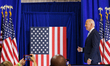 U.S. President Joe Biden greets people as he exits the stage at an event about lowering co...